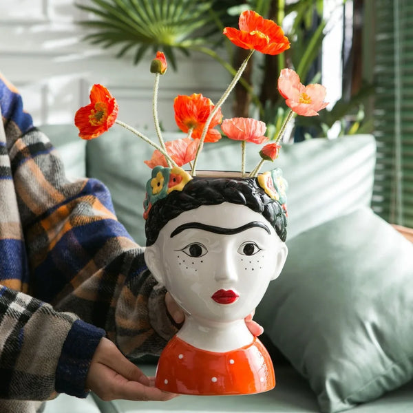 Hand-painted ceramic doll vase with floral design"