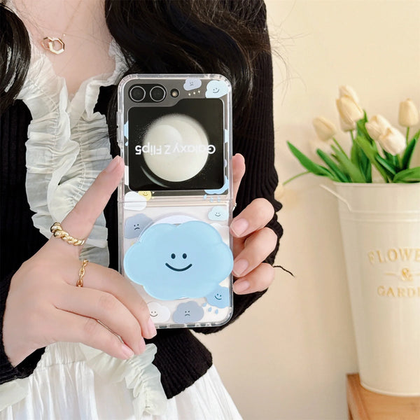 Close-up of a cute cloud phone case with a beaded strap in pastel colors, held by a woman