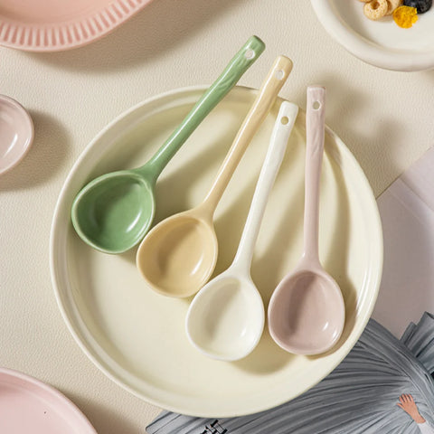 Stylish pastel ceramic spoons in green, yellow, white, and pink ready to enhance your tableware collection