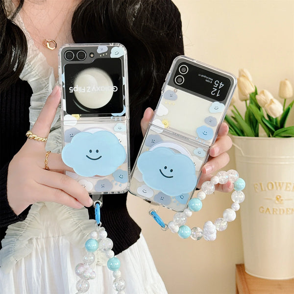 Close-up of a cute cloud phone case with a beaded strap in pastel colors, held by a woman