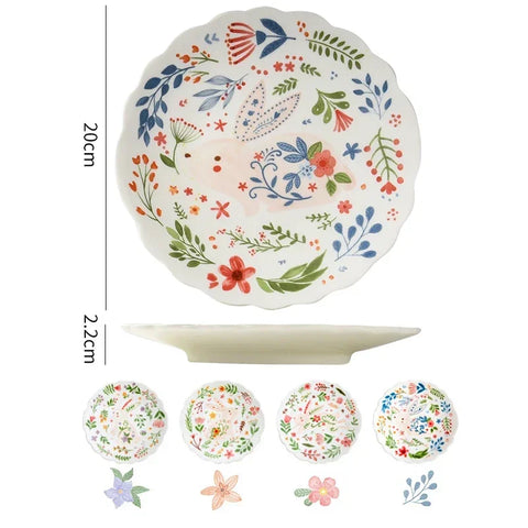 Colorful floral ceramic plates stacked on a table, showcasing intricate and vibrant flower and leaf patterns